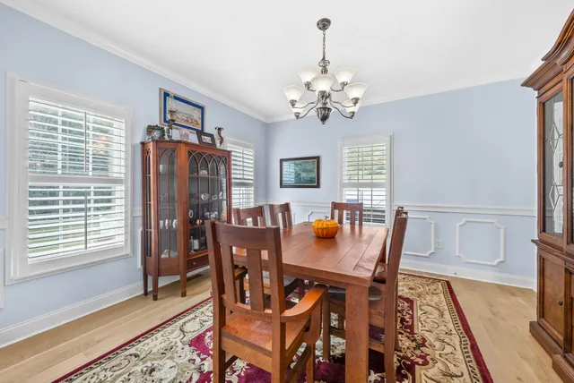 a kitchen with a stove a table and chairs