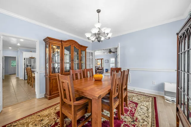 a kitchen with stainless steel appliances kitchen island granite countertop a stove refrigerator and cabinets