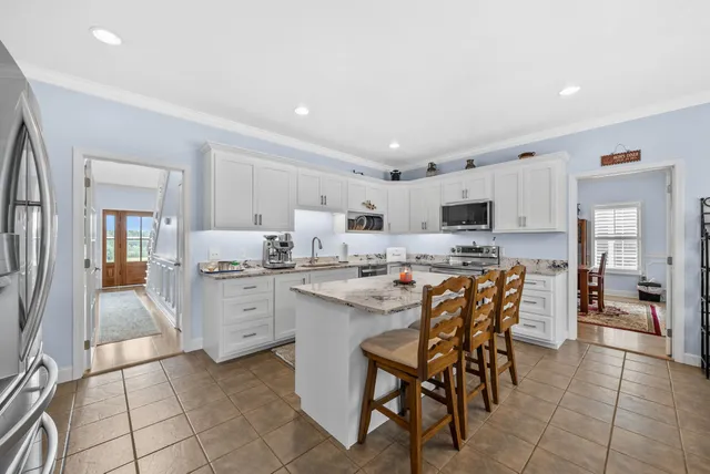 a bedroom with a bed window and a dresser