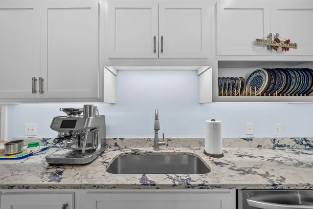 a bathroom with a window sink and mirror