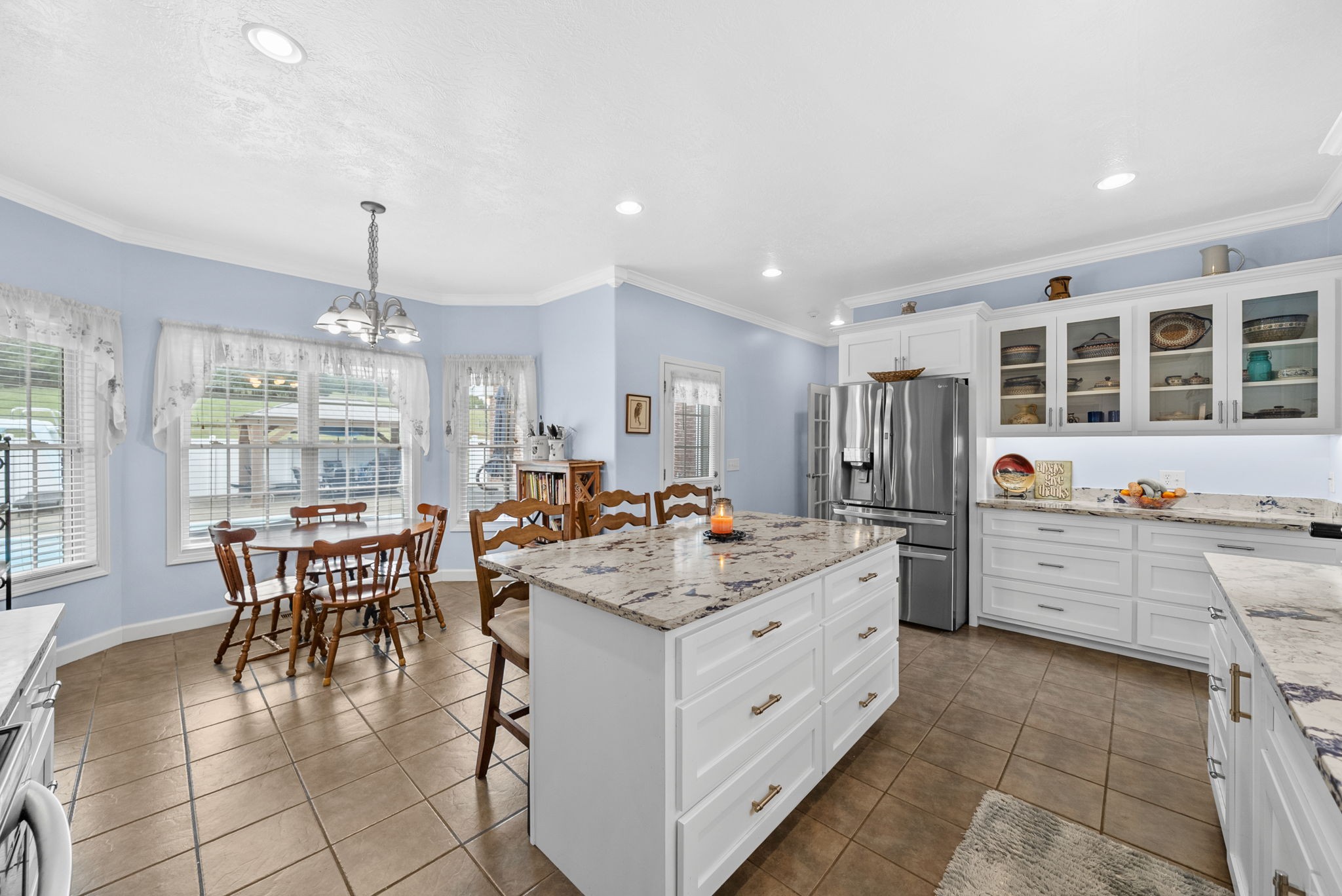 3989 Cadiz Road Bumpus Mills, TN 37028 - Photo 21 of 97 a kitchen with a stove a table and chairs