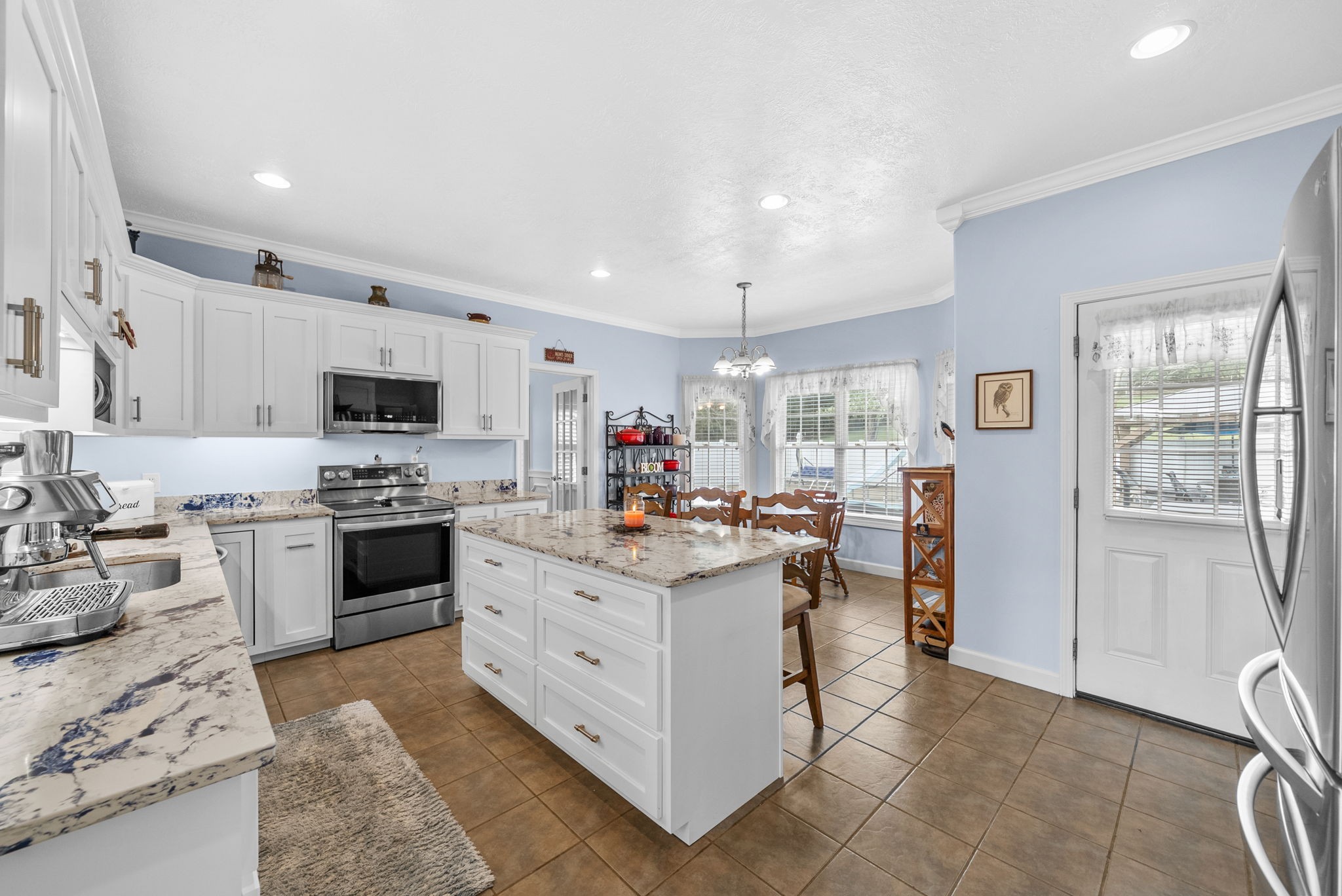3989 Cadiz Road Bumpus Mills, TN 37028 - Photo 23 of 97 a kitchen with stainless steel appliances kitchen island granite countertop a stove refrigerator and cabinets
