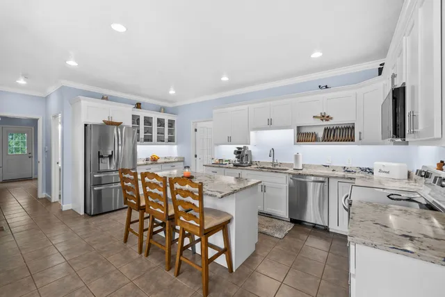 a bathroom with a double vanity sink mirror and shower