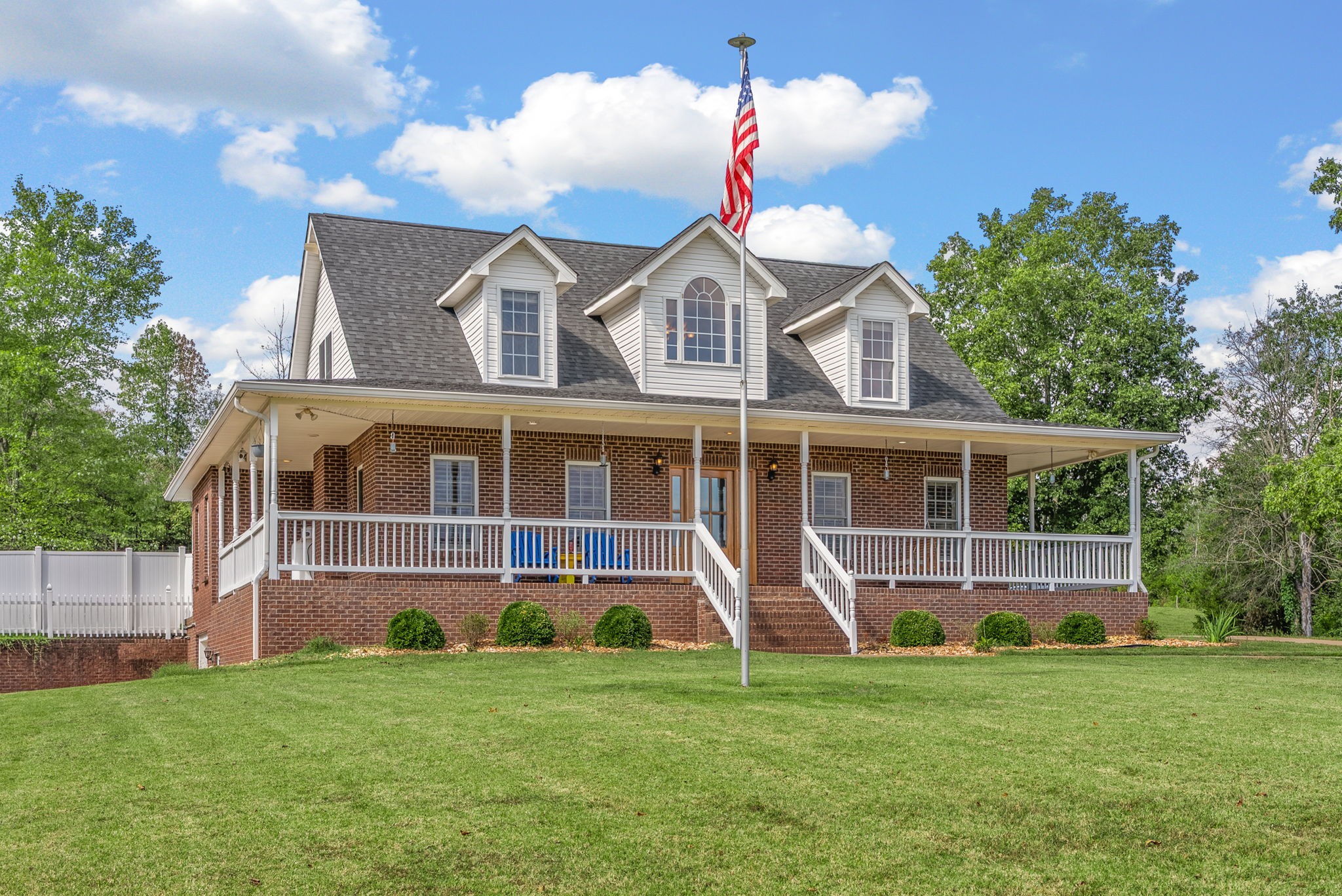 3989 Cadiz Road Bumpus Mills, TN 37028 - Photo 3 of 97 a front view of a house with a yard and trees