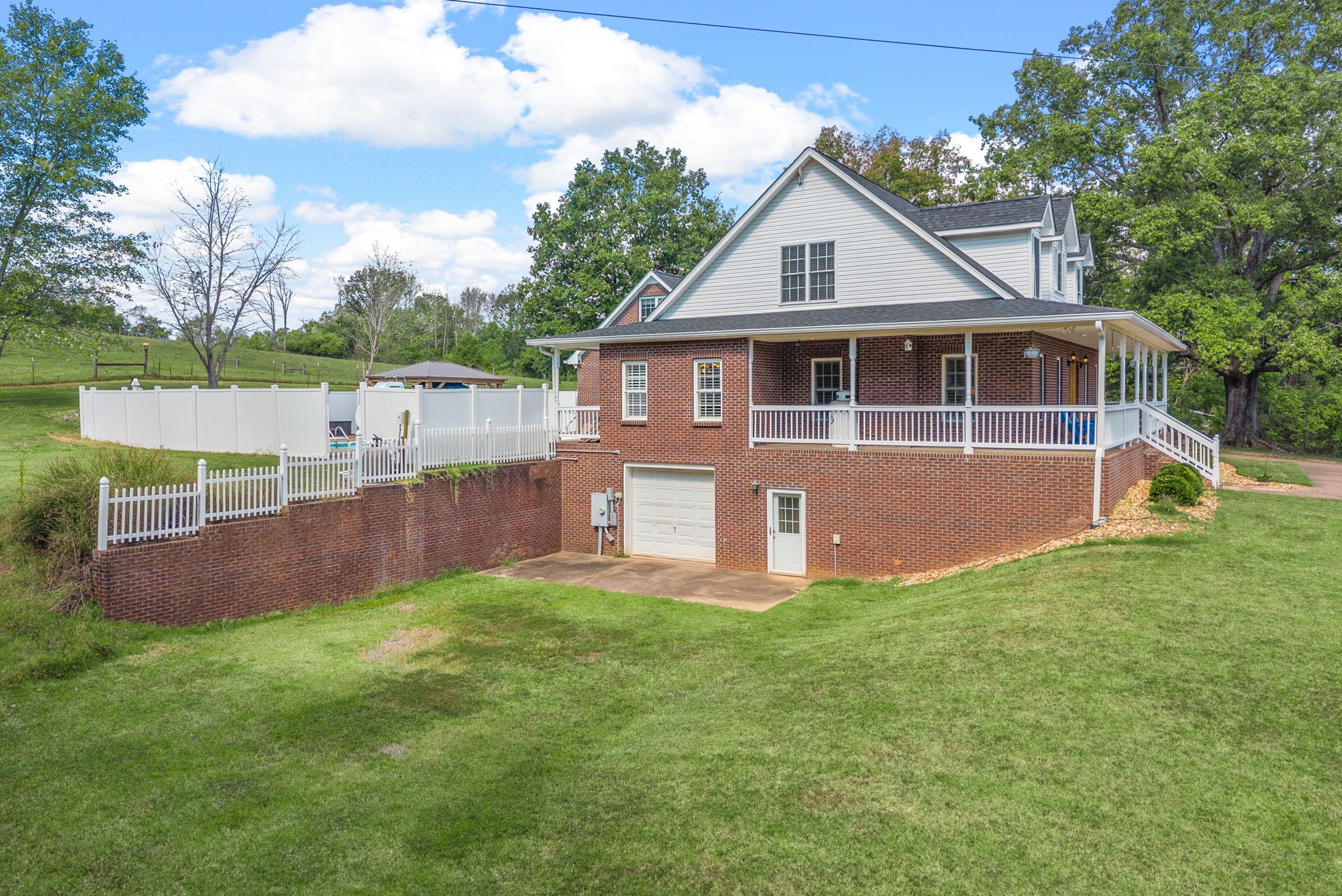 3989 Cadiz Road Bumpus Mills, TN 37028 - Photo 63 of 97 a front view of a house with a yard and trees
