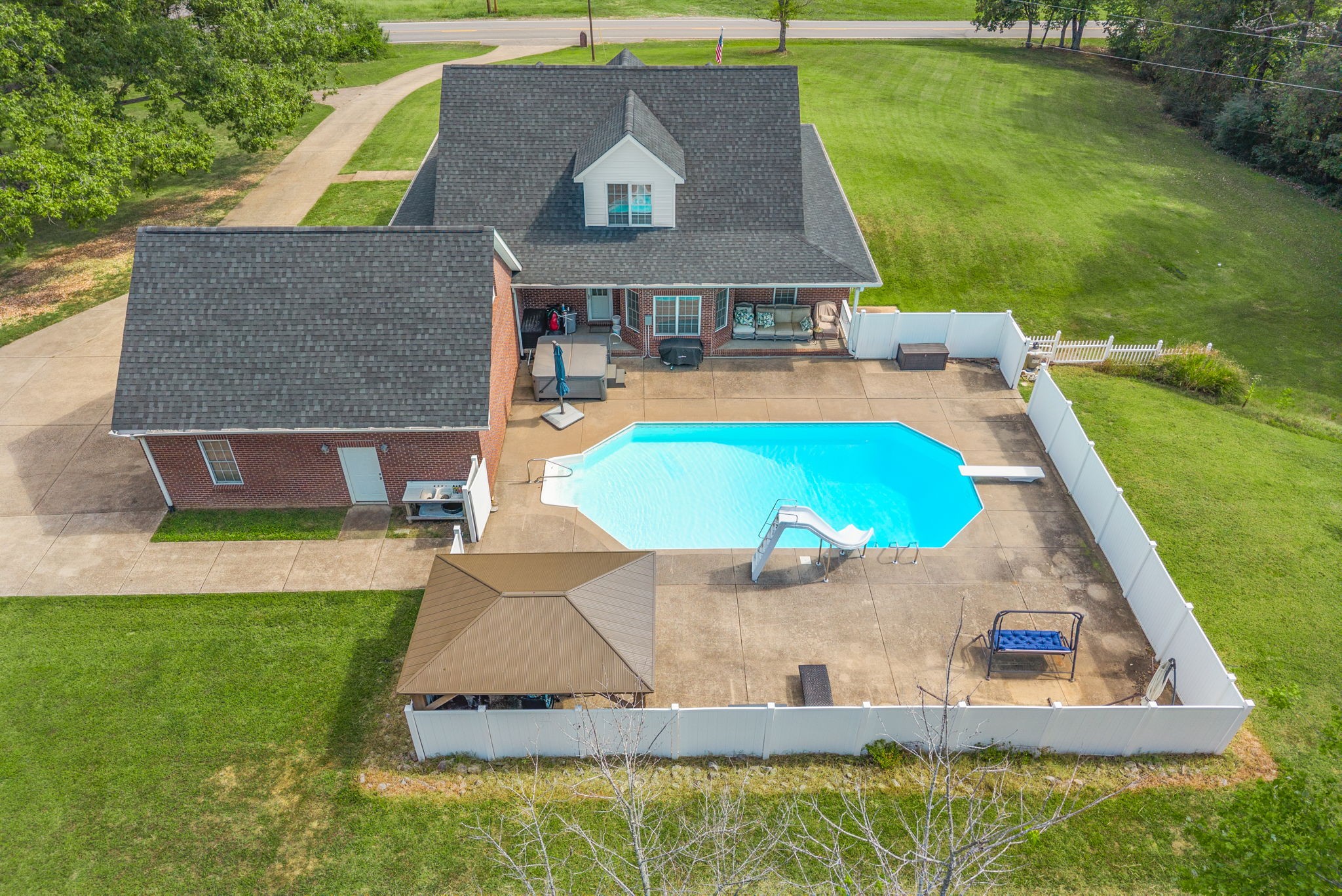 3989 Cadiz Road Bumpus Mills, TN 37028 - Photo 66 of 97 an aerial view of a house with swimming pool and a yard