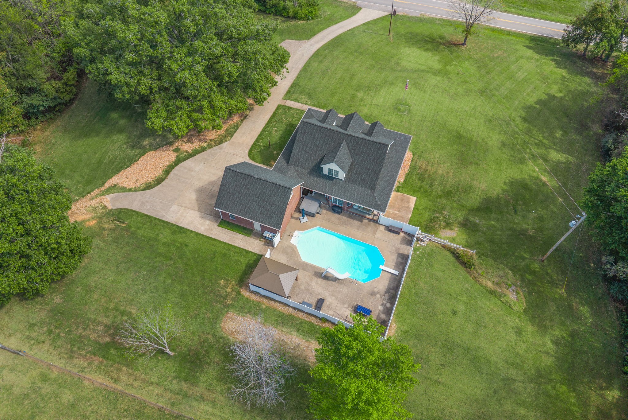 3989 Cadiz Road Bumpus Mills, TN 37028 - Photo 69 of 97 an aerial view of a house with a garden and lake view