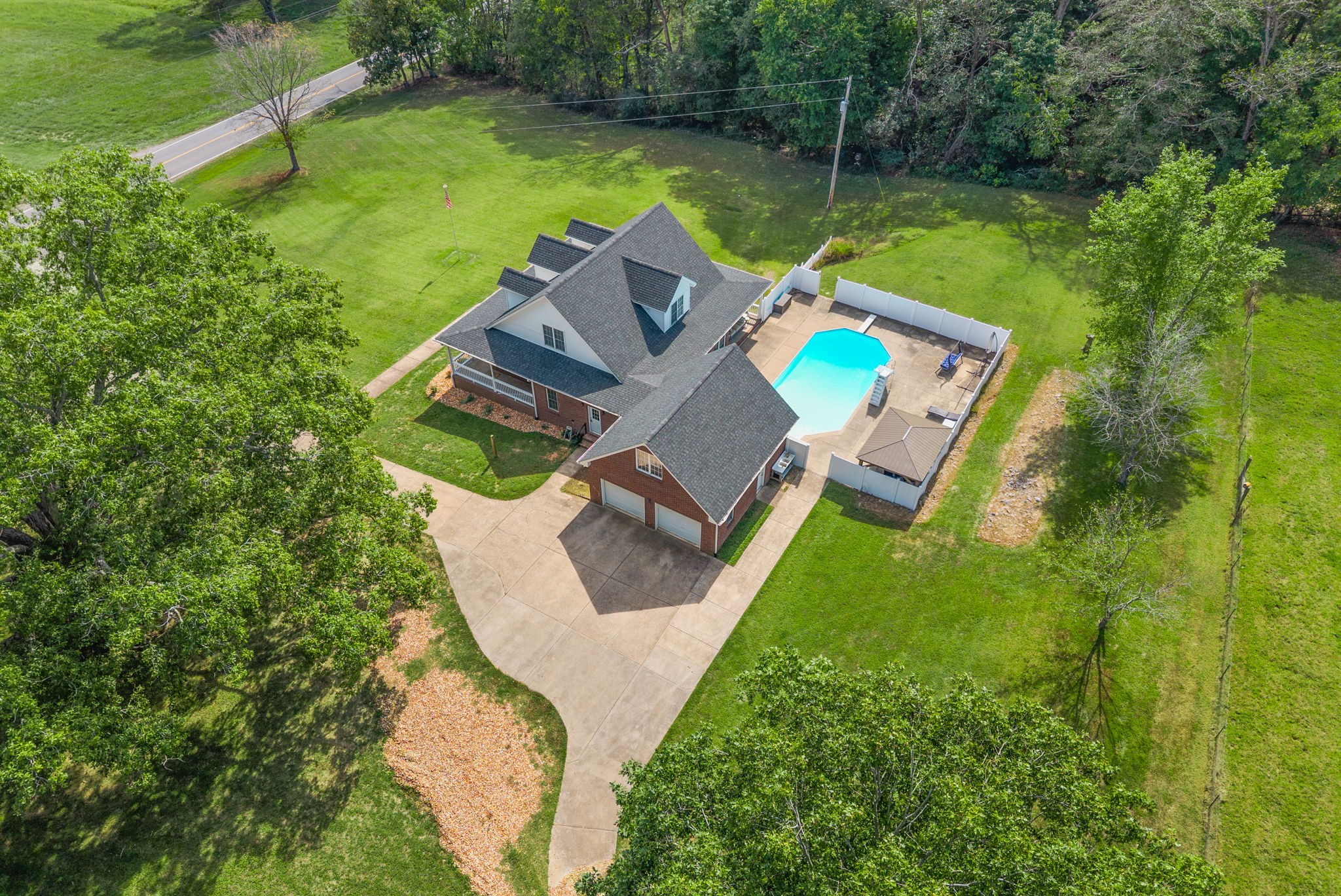 3989 Cadiz Road Bumpus Mills, TN 37028 - Photo 75 of 97 an aerial view of a house with pool a yard and outdoor seating