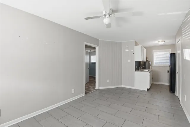 a view of a kitchen with a sink and a refrigerator