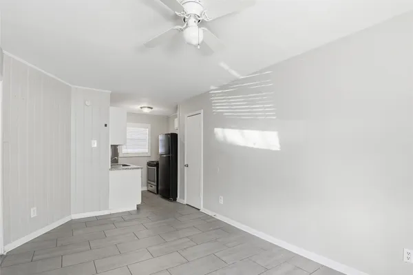 a view of a kitchen with a sink and a refrigerator