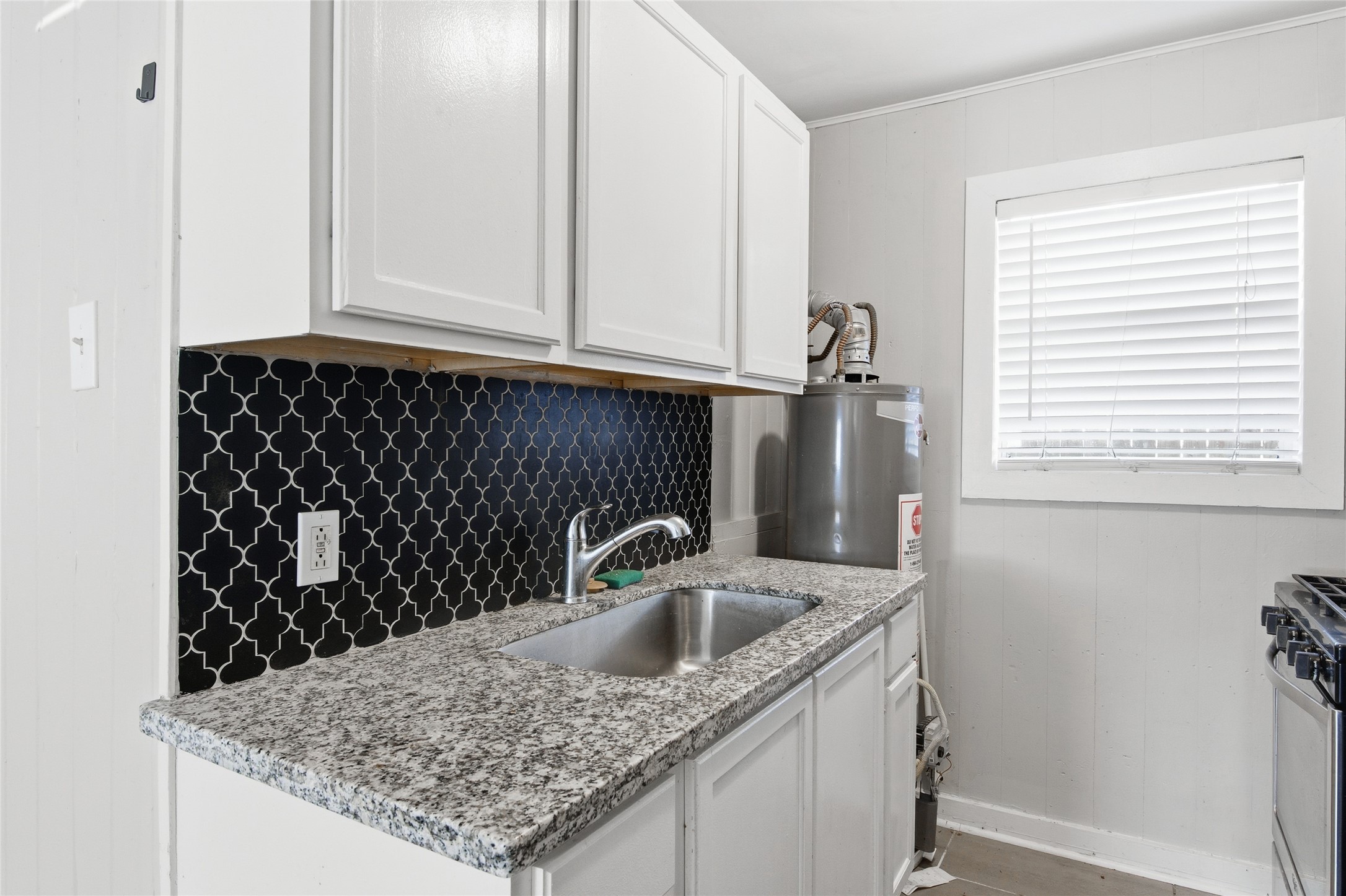 5010 Ennis Street, Unit 3 Houston, TX 77004 - Photo 7 of 12 a kitchen with a sink a refrigerator and window