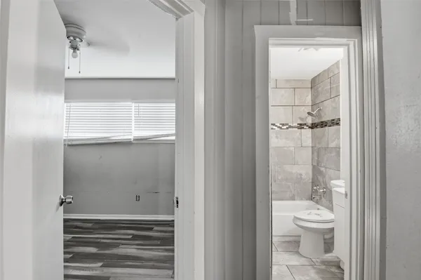 a bathroom with a toilet a sink and a window