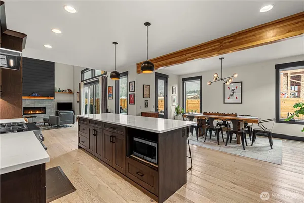 a kitchen with stainless steel appliances granite countertop a stove and a wooden floors