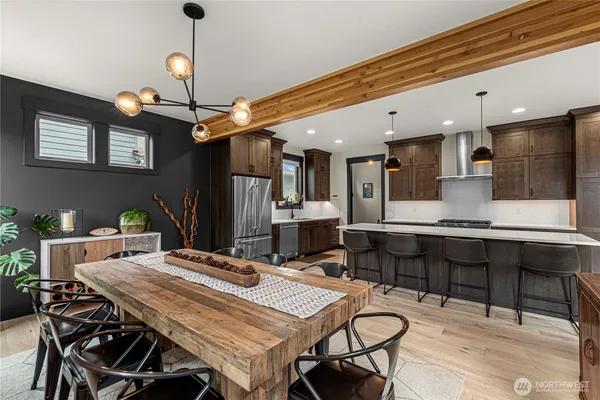 a dining room with a table chairs and kitchen view