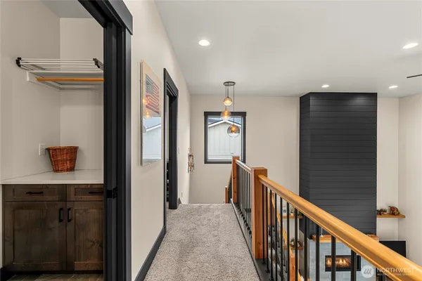 a view of a hallway with wooden floor and staircase