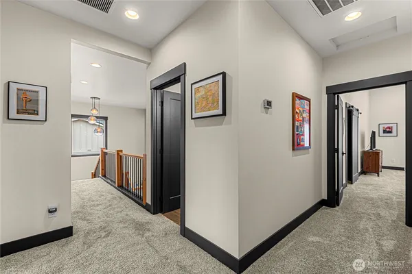 a view of a hallway with bathroom