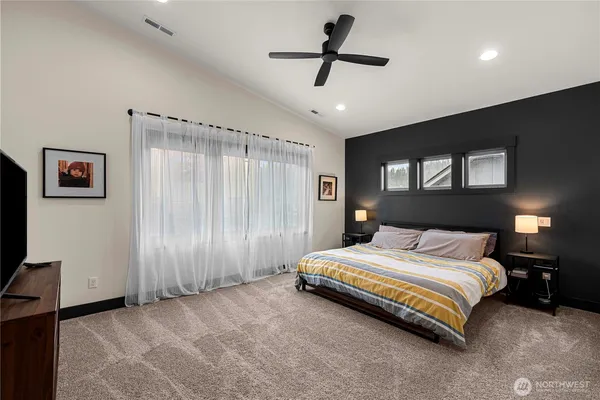 a spacious bedroom with a bed and a walk in closet