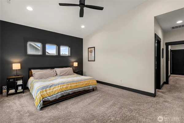 a bedroom with a bed and a night stand