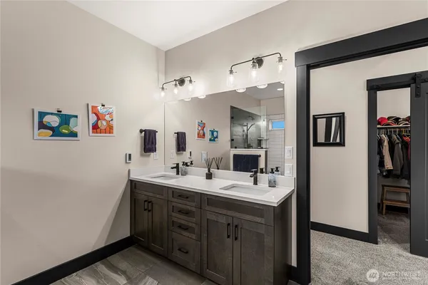 a spacious bathroom with a double vanity sink and a mirror