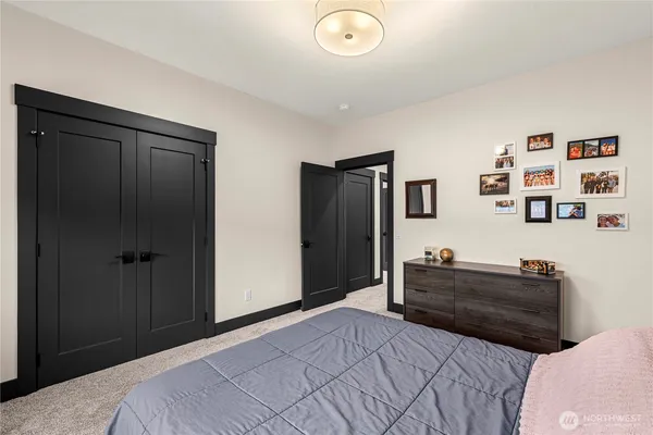 a bedroom with a bed and cabinets