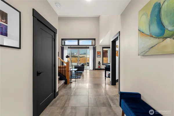 a view of a hallway with dining area and chandelier