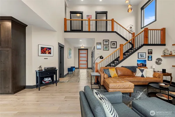 a living room with furniture and a book shelf