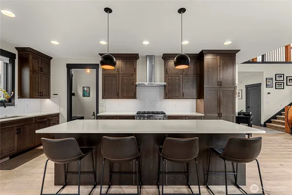 a kitchen with a dining table chairs and refrigerator