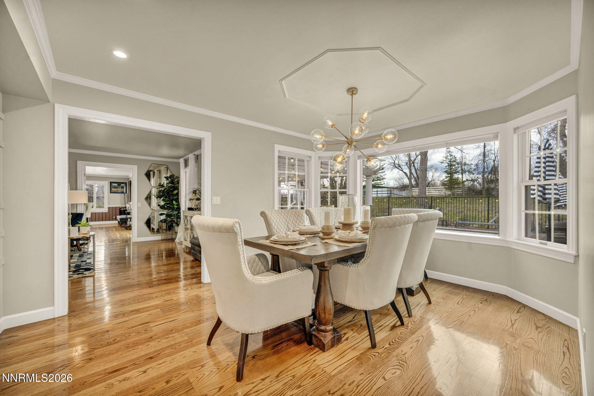 2501 Holcomb Ranch Lane Reno, NV 89511 - Photo 64 of 94 a dining room with wooden floor a chandelier a glass table and chairs