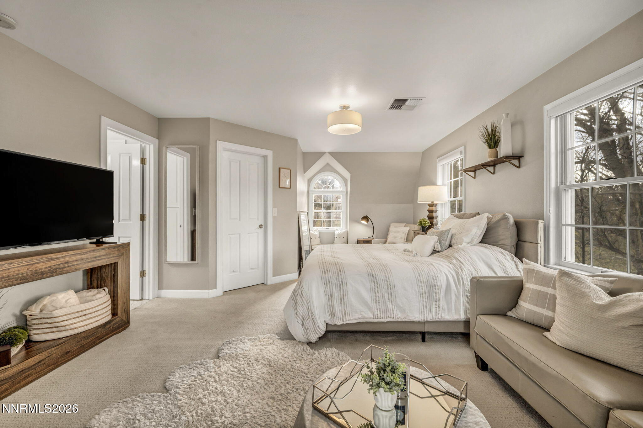 2501 Holcomb Ranch Lane Reno, NV 89511 - Photo 82 of 94 a spacious bedroom with a bed and a flat screen tv