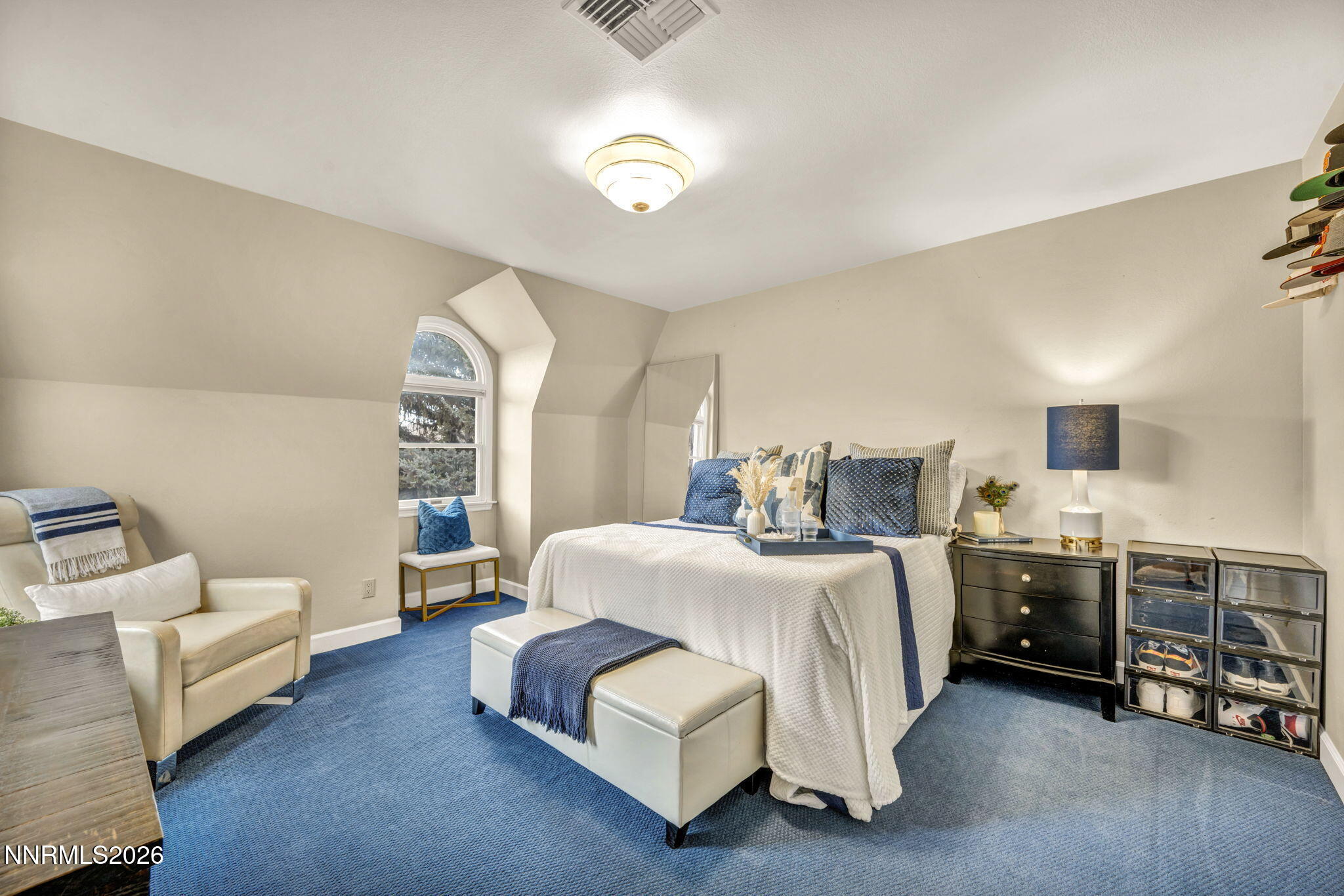 2501 Holcomb Ranch Lane Reno, NV 89511 - Photo 90 of 94 a spacious bedroom with a bed and a couch