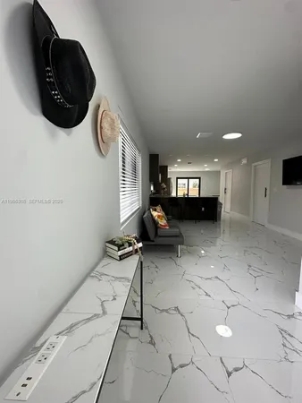 a view of entryway and kitchen