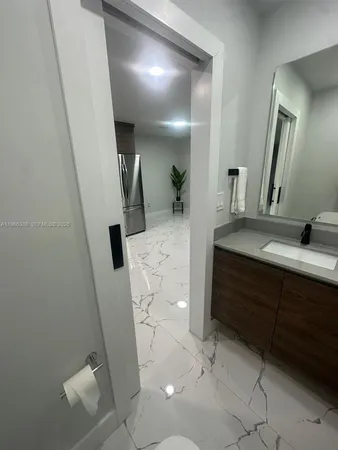 a bathroom with a sink a toilet and mirror