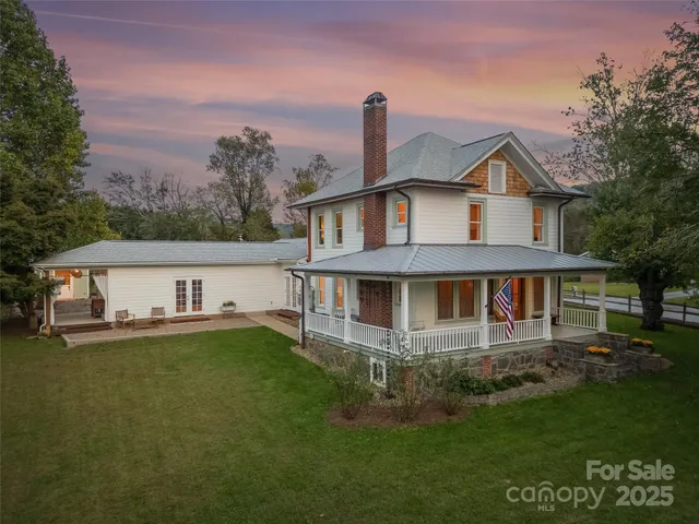 a front view of a house with a yard table and chairs