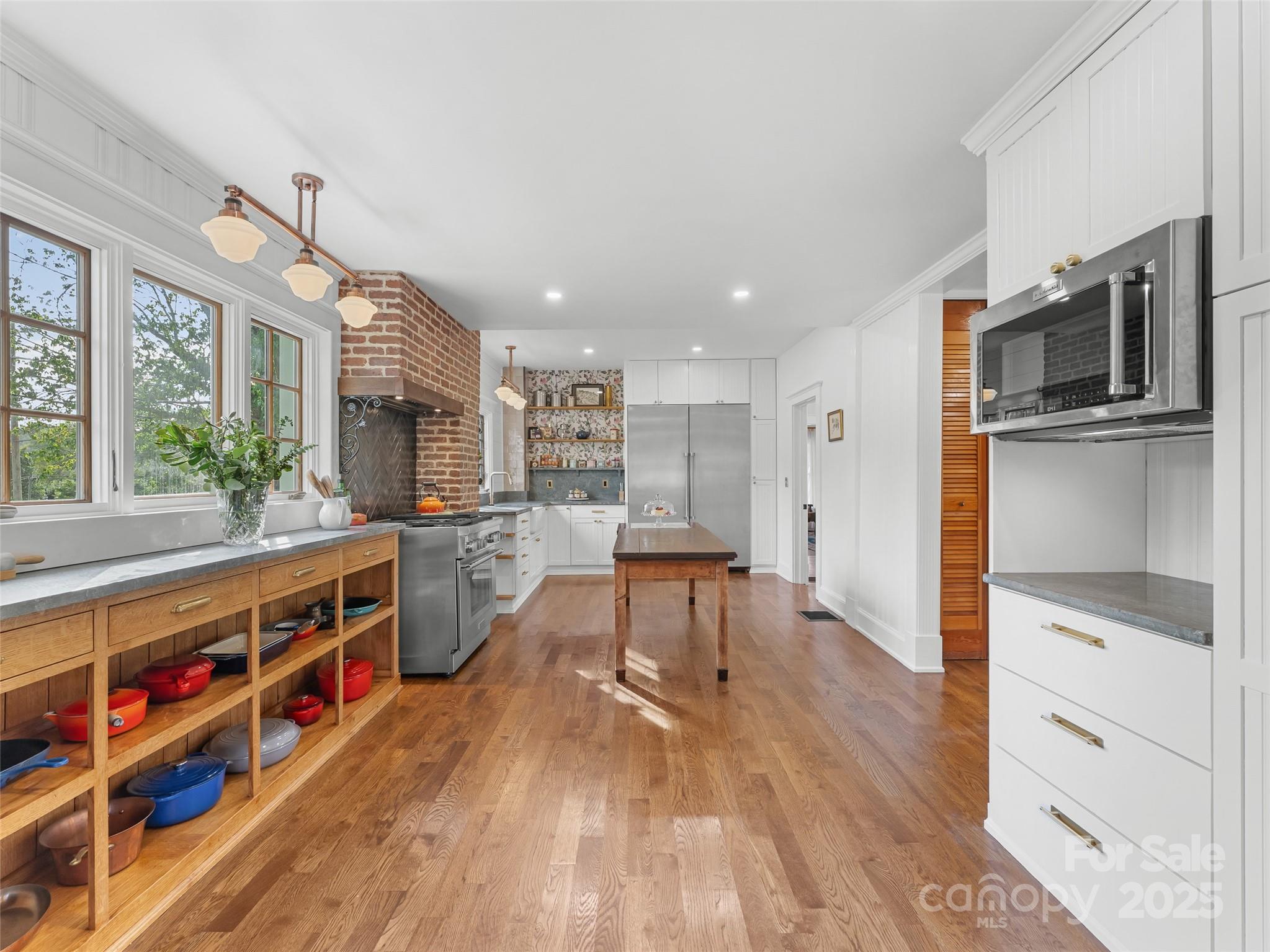 505 North Country Club Road Brevard, NC 28712 - Photo 16 of 48 a kitchen with stainless steel appliances a stove and a wooden floor