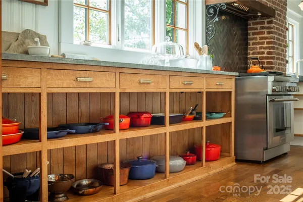 a kitchen with refrigerator and stove