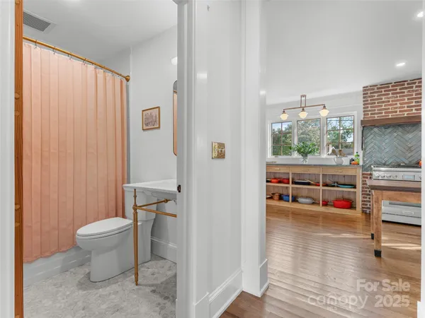 an empty room with furniture and a chandelier