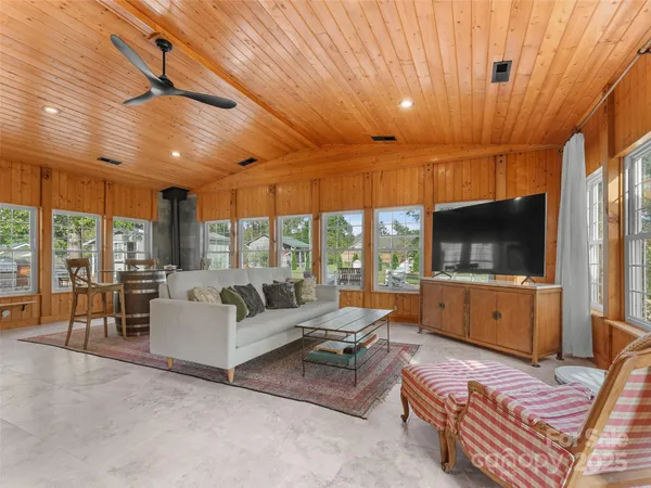 a dining room with furniture a chandelier and a rug
