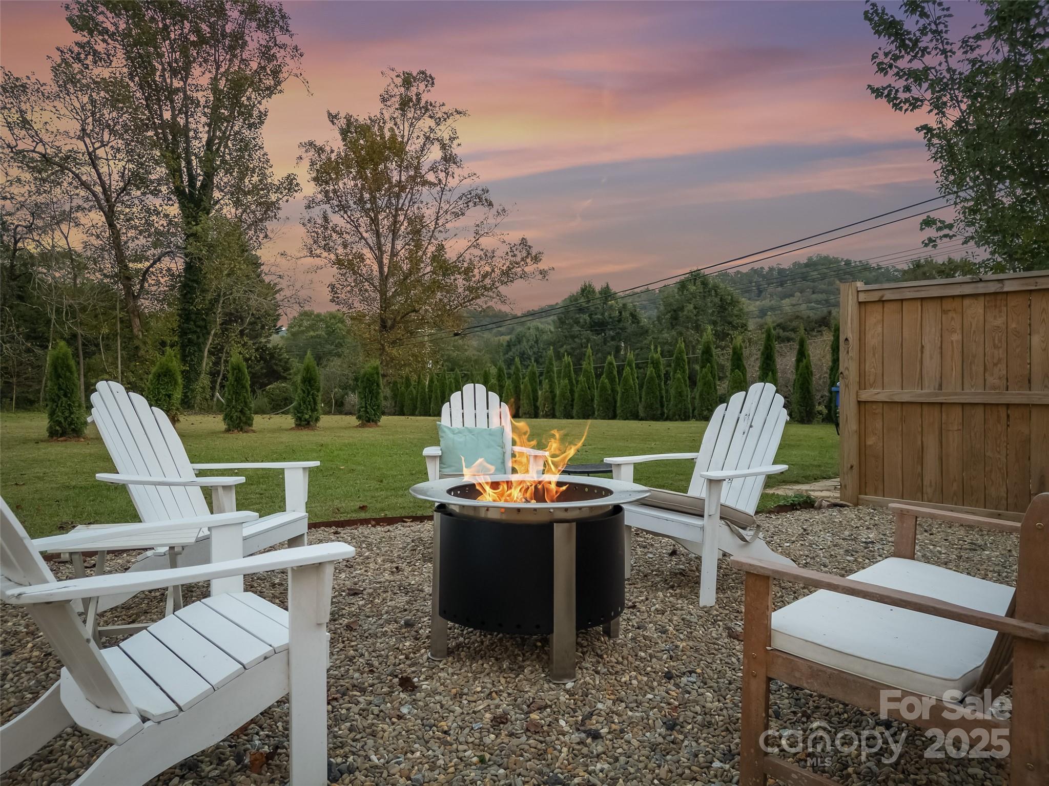 505 North Country Club Road Brevard, NC 28712 - Photo 46 of 48 a view of a chairs and table in the back yard of the house