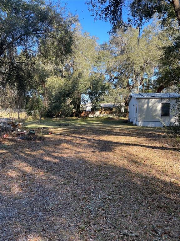 2798 Northeast 34th Road Wildwood, FL 34785 - Photo 4 of 7 a view of dirt yard with large trees