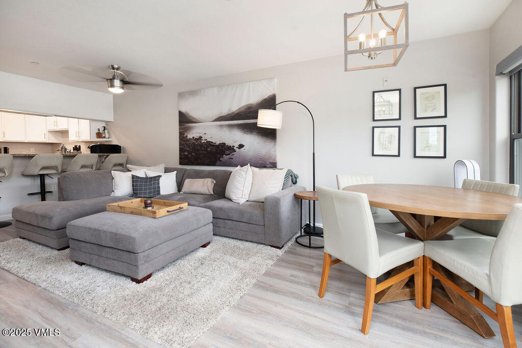 a living room with furniture a table and wooden floor