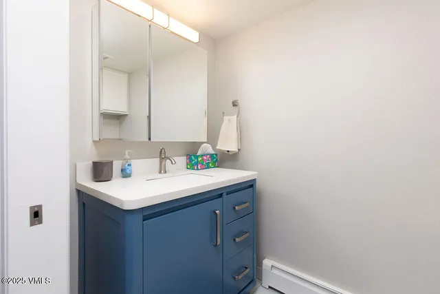 a bathroom with a sink and a mirror