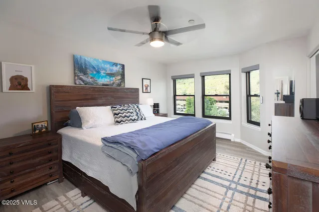 a bedroom with a large bed and a window