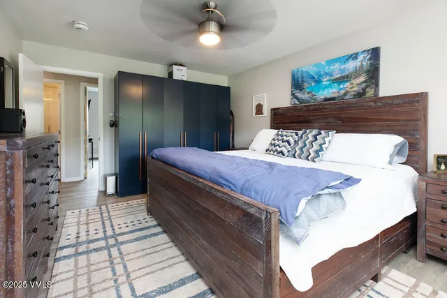 a bedroom with bed and a chandelier