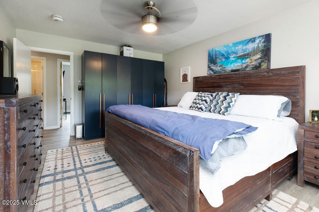 216 Main Street, Unit R316 Edwards, CO 81632 - Photo 9 of 12 a bedroom with bed and a chandelier