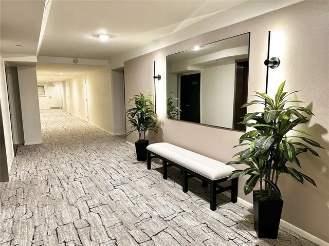 a view of a patio with table and chairs under an umbrella