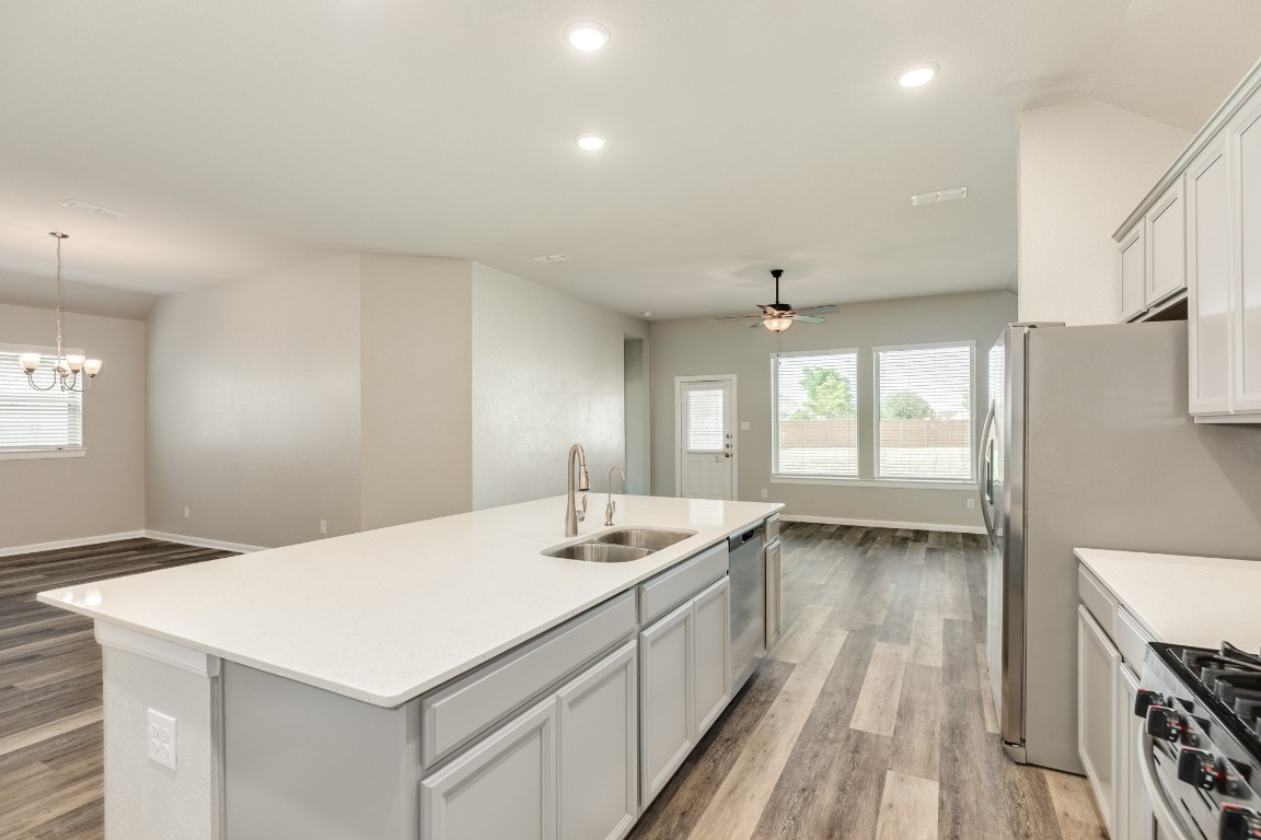 4946 Hitchings Court Rosharon, TX 77583 - Photo 14 of 49 The oversized island features storage, a dishwasher, and seating for bar stools on the opposite side.