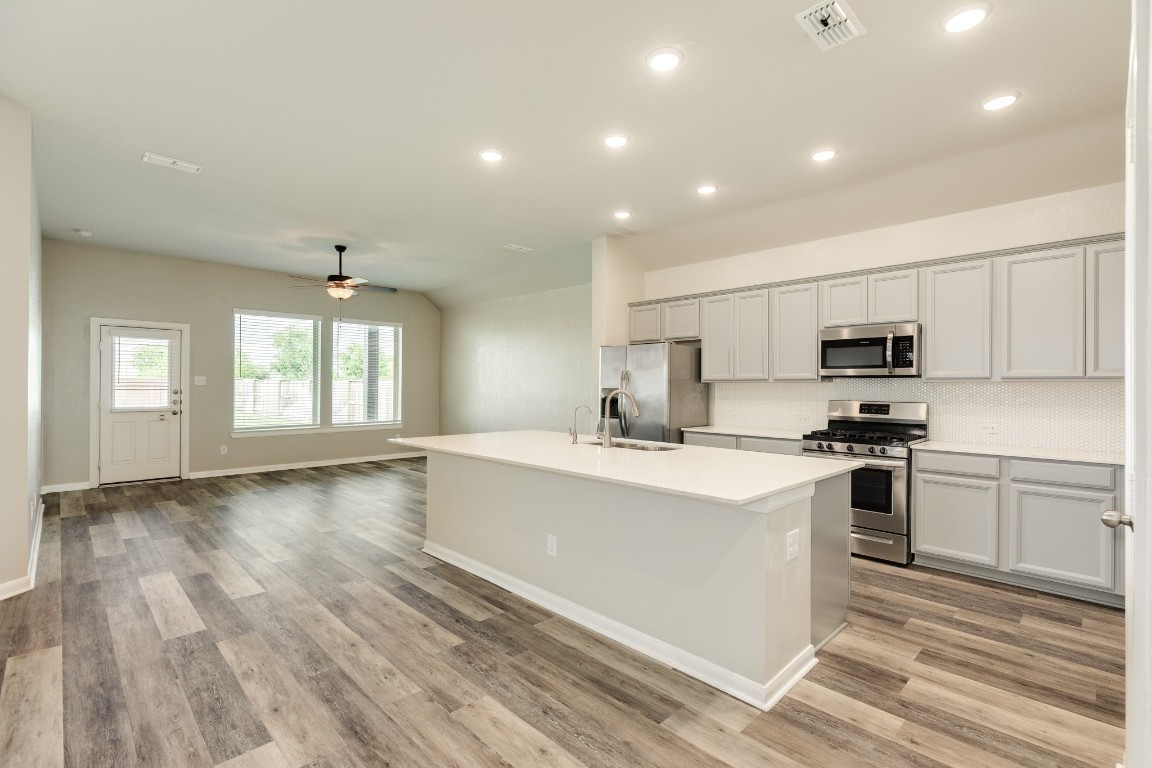 4946 Hitchings Court Rosharon, TX 77583 - Photo 16 of 49 This view showcases the beautiful floors and stainless steel appliances.