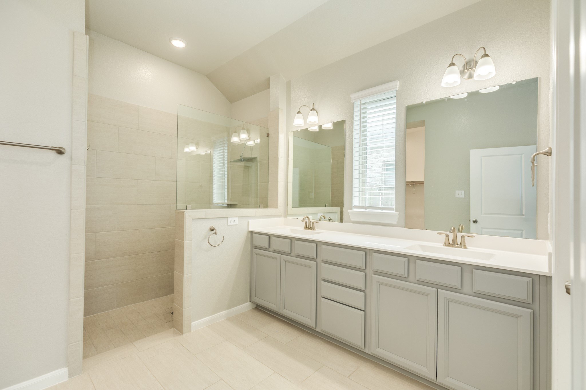 4946 Hitchings Court Rosharon, TX 77583 - Photo 20 of 49 Primary bath features an oversized, walk-in, doorless shower, double vanities with excellent lighting, ample storage, and tile flooring.