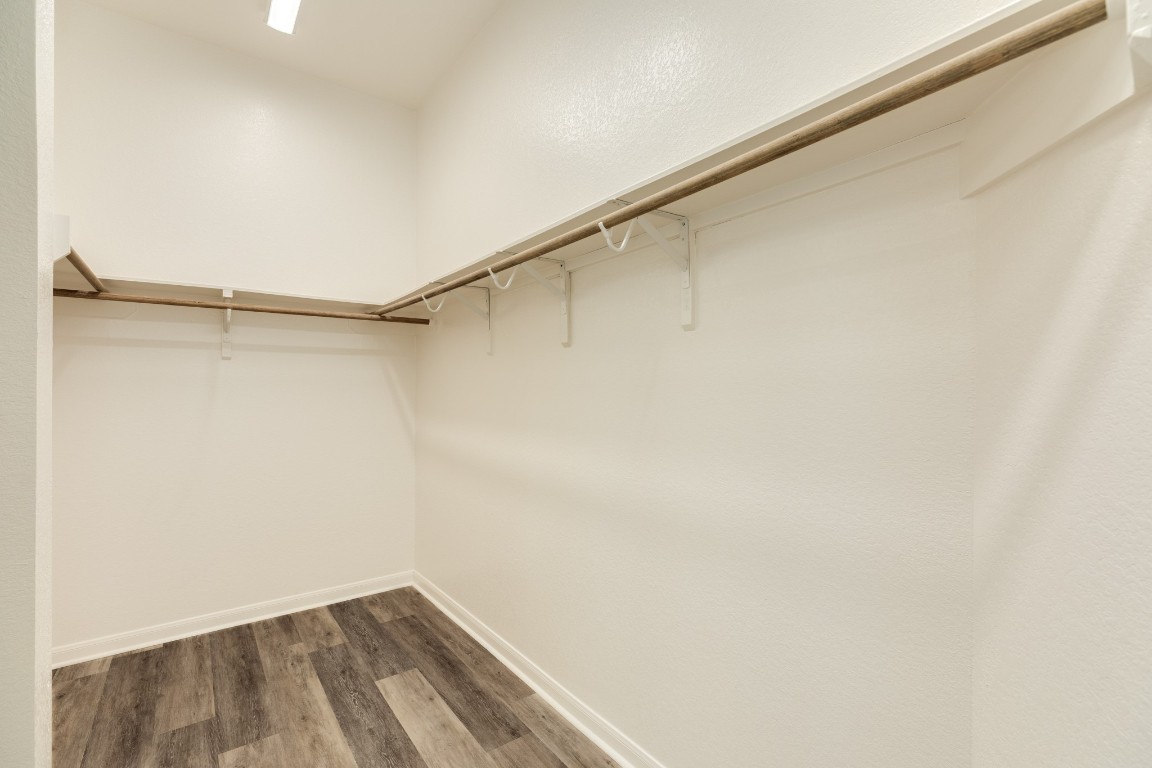 4946 Hitchings Court Rosharon, TX 77583 - Photo 21 of 49 Primary bedroom features a very large walk-in closet, complete with clothes racks and storage shelves.