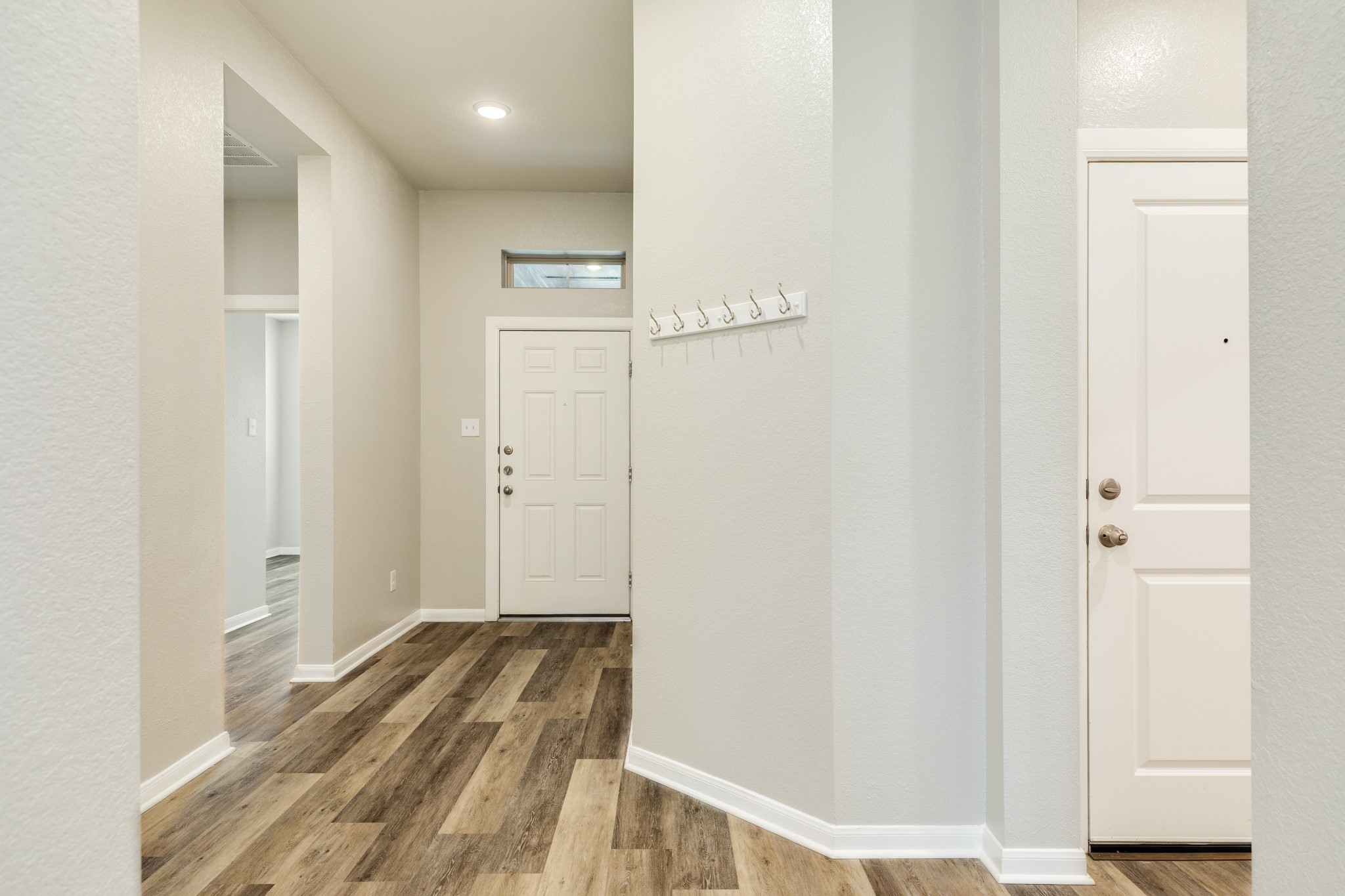 4946 Hitchings Court Rosharon, TX 77583 - Photo 3 of 49 Upon entering, the front door reveals beautiful engineered wooden floors, elegantly showcased throughout the home.